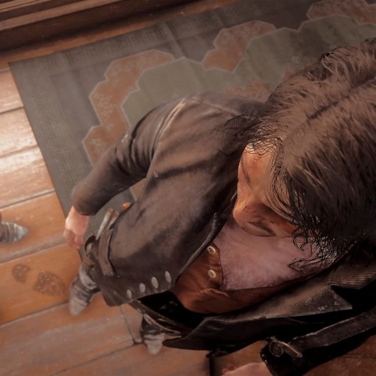 an image of a man laying on the floor with his head down and hands in his pockets