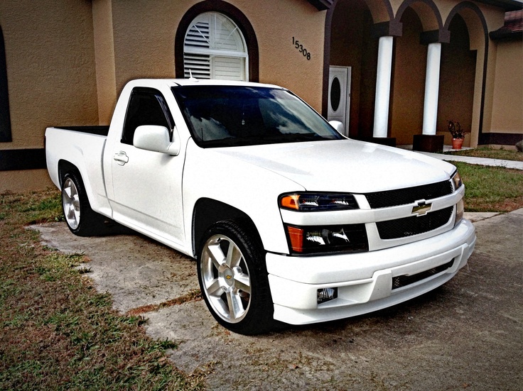 a white truck parked in front of a house