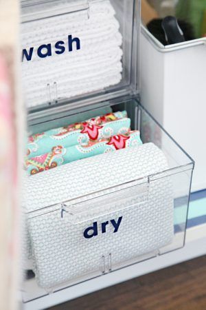 an organized drawer with towels and toiletries in it that says wash dry on the bottom