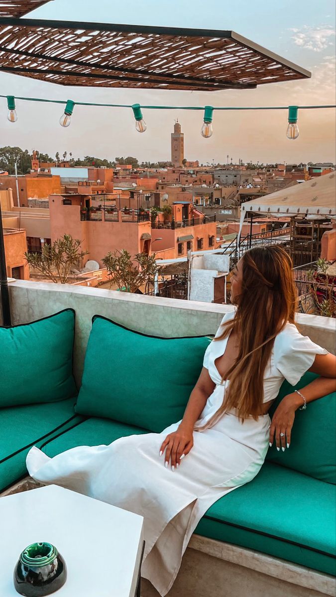 a woman sitting on top of a green couch