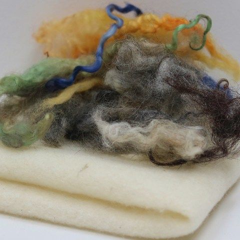 two pieces of wool sit on top of each other