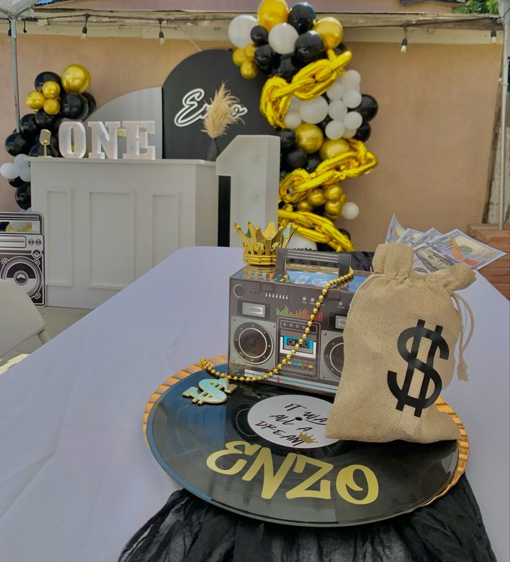 a table topped with a record player and money bag