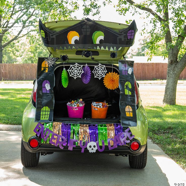 the trunk of a car decorated for halloween with decorations and decorations on it's roof