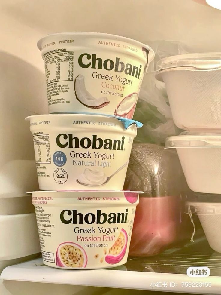 three yogurts are stacked on top of each other in the refrigerator with plastic containers