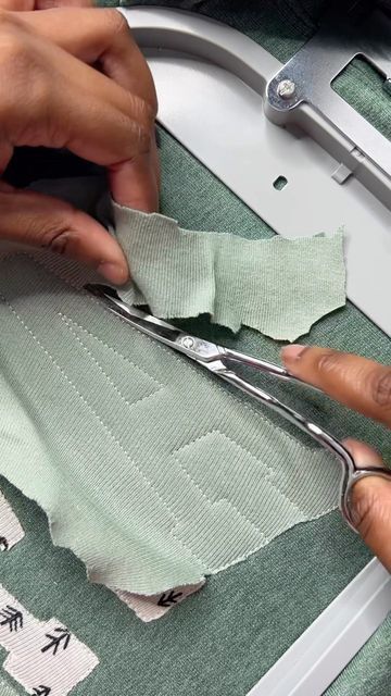 someone cutting fabric with scissors on a sewing machine