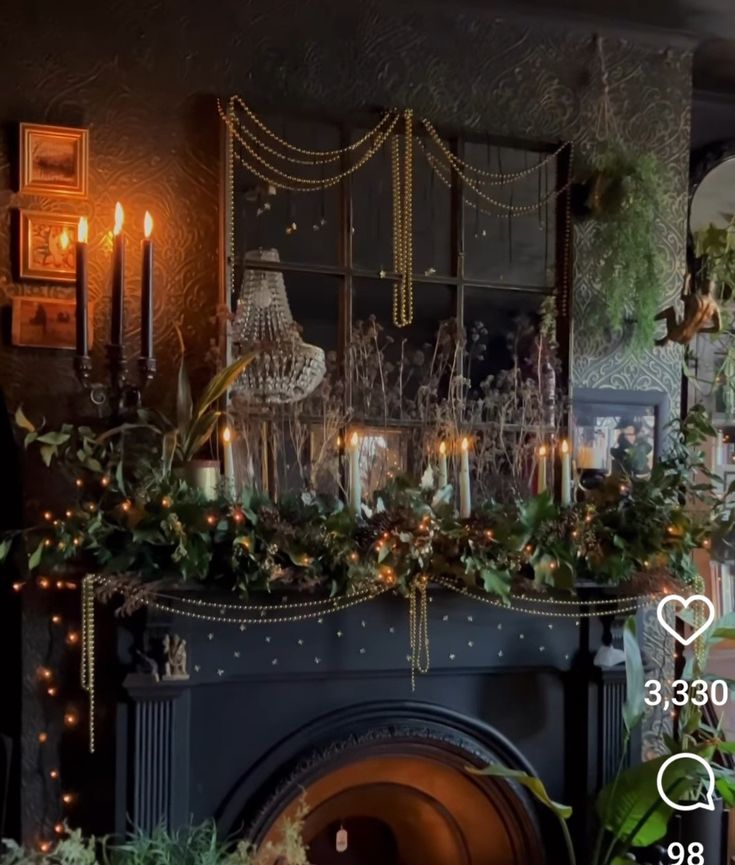 a fireplace with candles and greenery on it in front of a mirror that says love