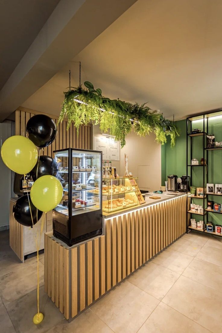 a bakery with balloons and greenery hanging from the ceiling