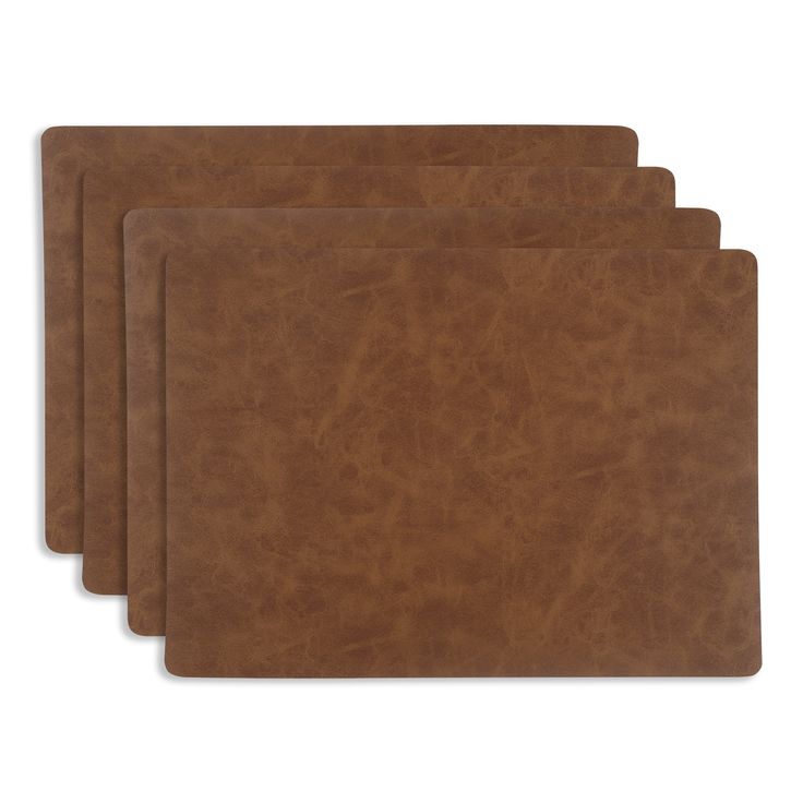 four brown leather placemats on a white background