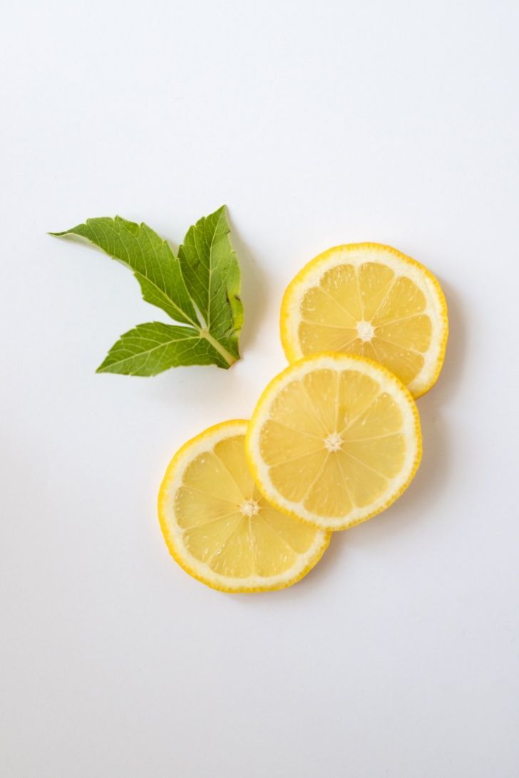 three lemons cut in half with green leaves