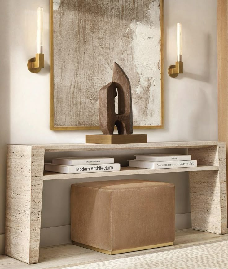 a modern console table with an abstract painting in the background