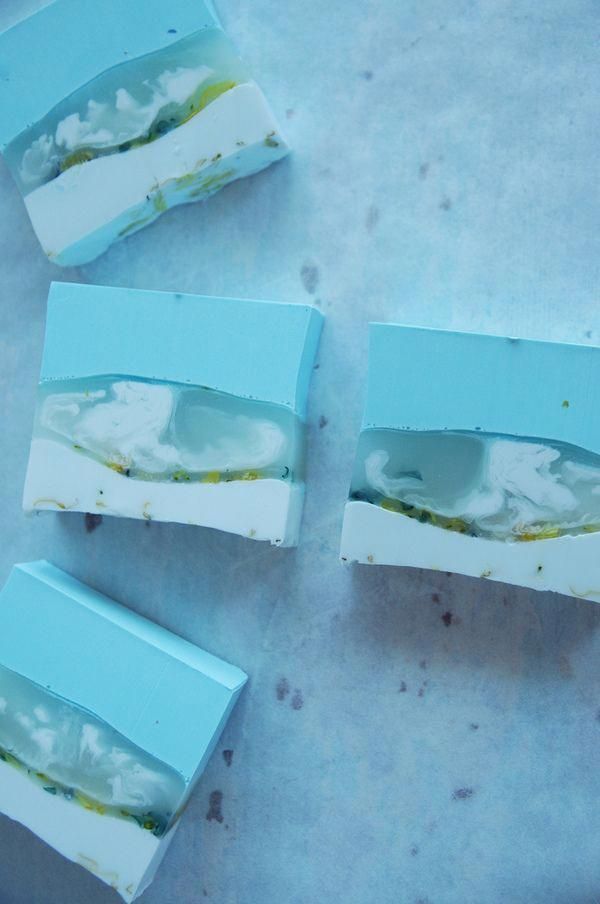 three pieces of blue and white soap sitting on top of a counter next to each other