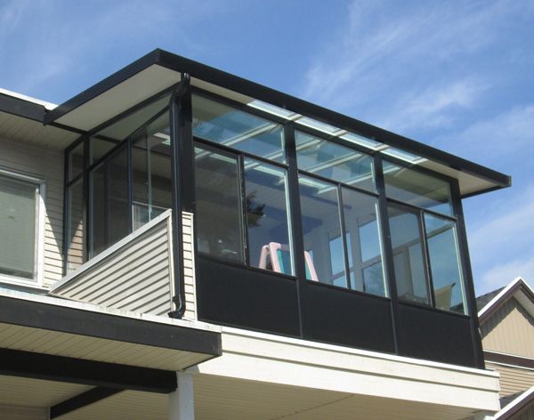 a house with a balcony and glass balconies