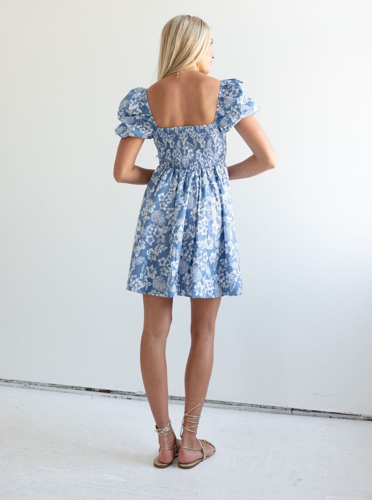 The Ellie Floral Dress features a square neckline, elasticizes puff sleeves and a smocked back to ensure a perfect fit in the bodice. This mini dress pairs perfectly with sneakers or sandals and your favorite tote. Fit: True to sizeFabric Content: 100% CottonFabric Care: Machine Wash Cold Gentle Cycle, lay flat to dryMeasurements: 37" Shoulder to hemLining: Yes 100% PolyesterZipper: No S:0-2 M:4-6 L:8-10 Blue Short Sleeve Dress With Floral Patchwork, Blue Floral Print Playtime Dress, Light Blue Floral Print Mini Dress, Light Blue Floral Print Short Sleeve Mini Dress, Light Blue Floral Print Knee-length Mini Dress, Tee Bag, Hunter Bell, Sea New York, Belle Dress