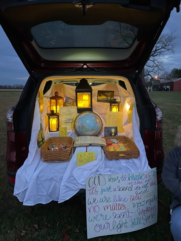 the back end of a car with its trunk open and various items on display in it