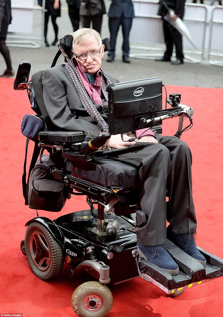 an old man in a wheel chair on a red carpet