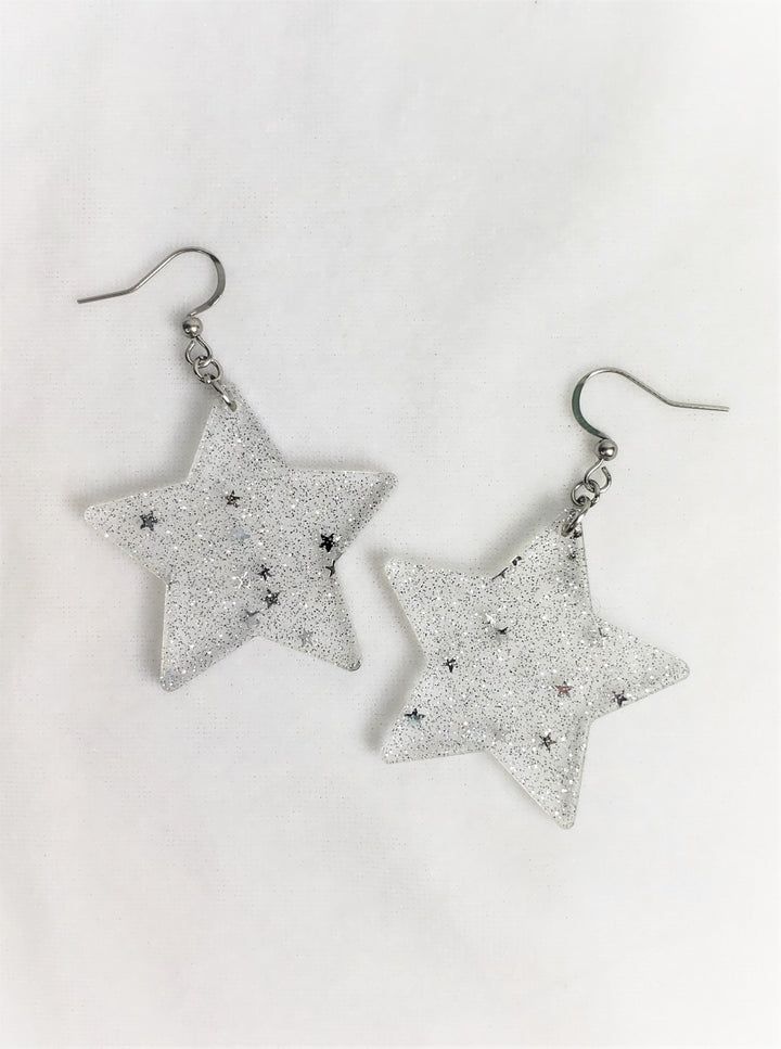 Sparkle Star Earrings – retroelo Silver Star Charm Earrings For Party, Handmade Trendy Silver Plug Earrings, Trendy Handmade Silver Plug Earrings, Silver Stainless Steel Plug Earrings As Gift, Nickel-free Star Jewelry For Parties, Silver Star-shaped Earrings, Silver Star-shaped Earrings With Ear Wire, Nickel Free Star Shaped Party Jewelry, Trendy Silver Star Earrings