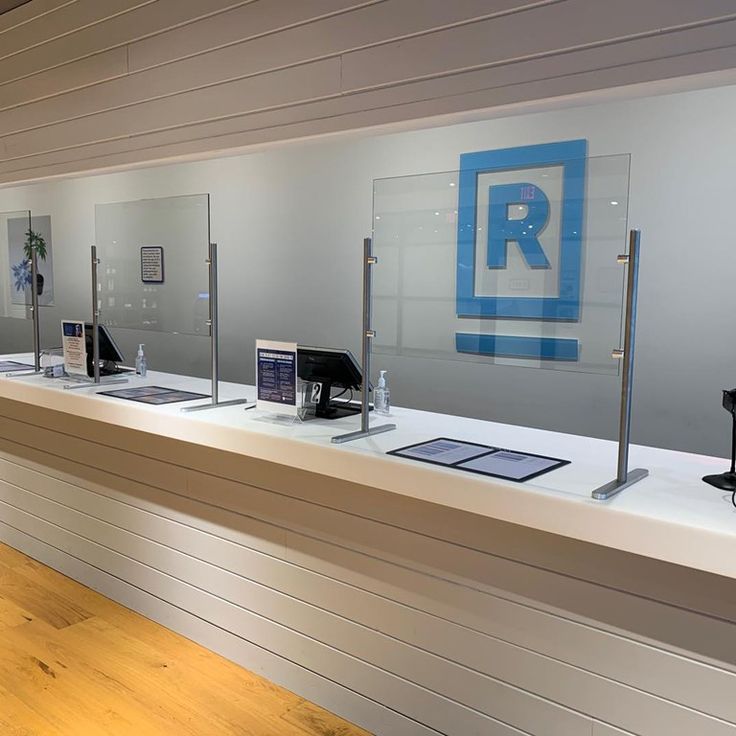 a row of glass shelves with electronic devices on them in a museum like setting,