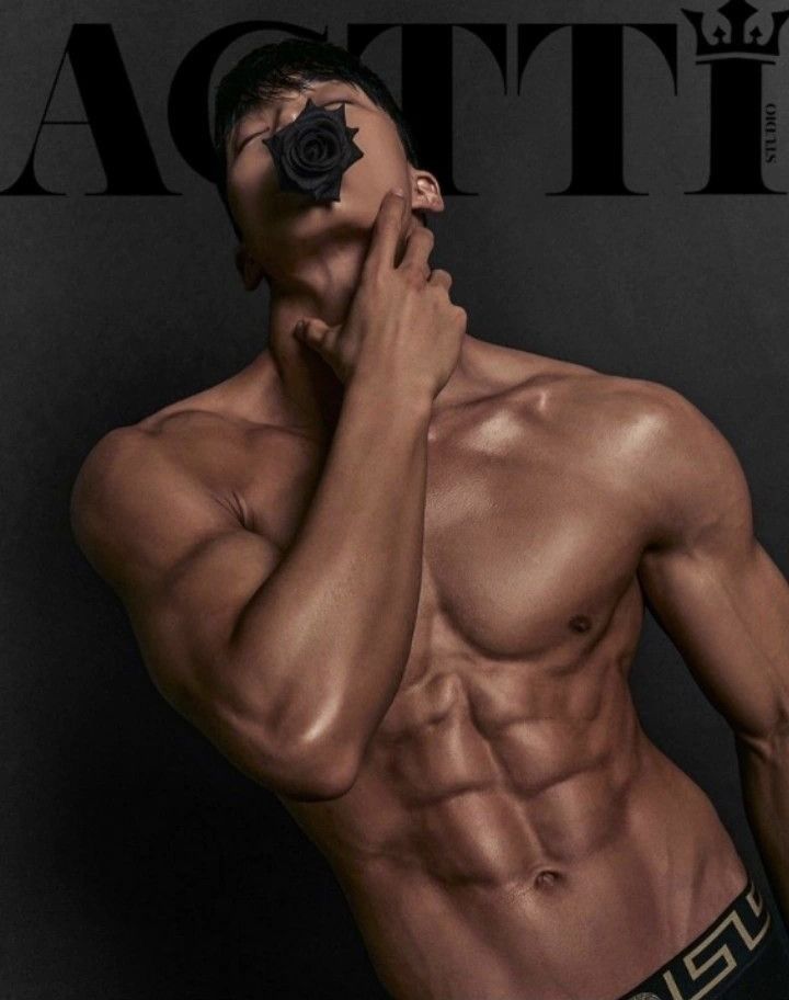 a shirtless man holding his hand to his face while posing for a magazine cover