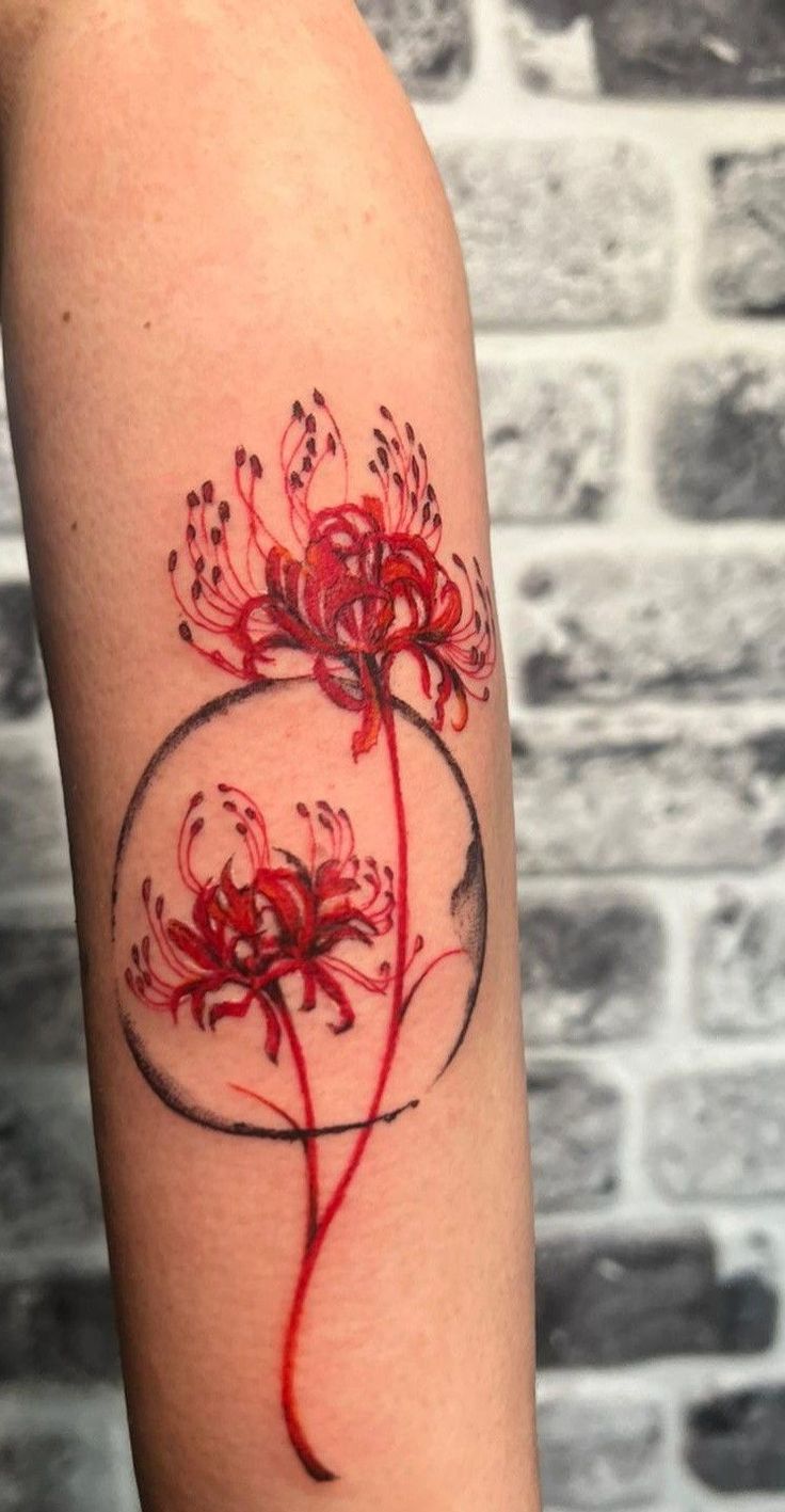 a tattoo with red flowers on the arm