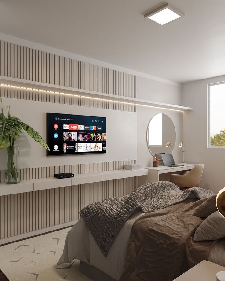 a bedroom with a large flat screen tv mounted on the wall next to a bed