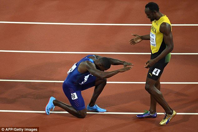 two men on a track with one kneeling down