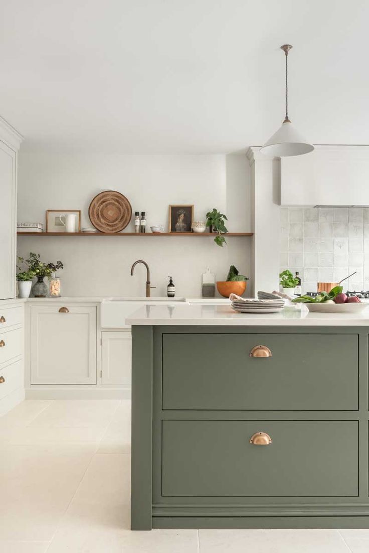 a kitchen with white walls and green cabinets