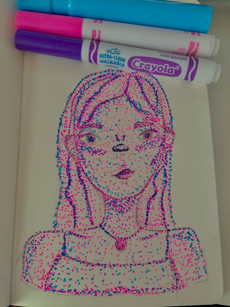 a drawing of a girl with pink hair and blue eyes is next to crayons