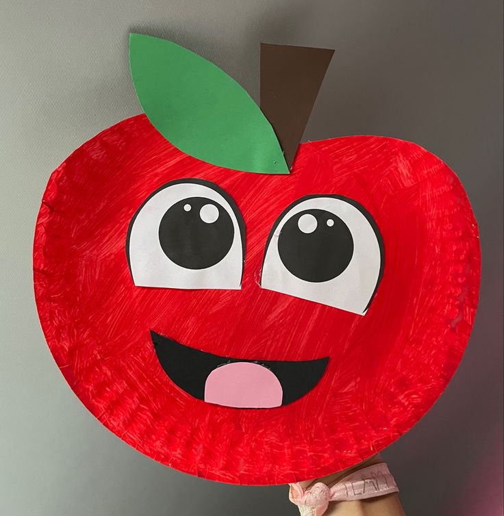 a paper plate that has an apple on it