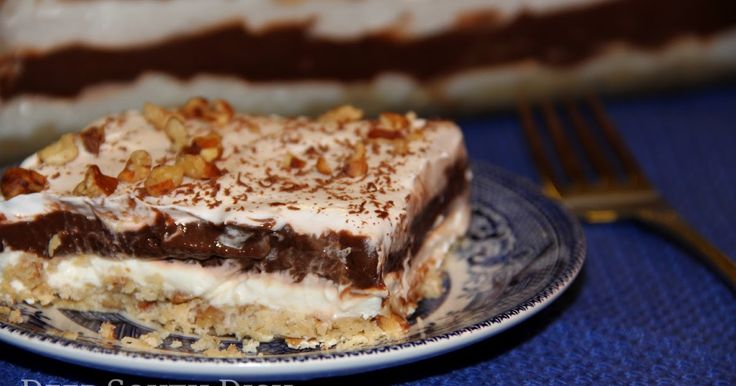 a piece of dessert sitting on top of a blue and white plate next to a fork