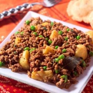 a white plate topped with meat and peas