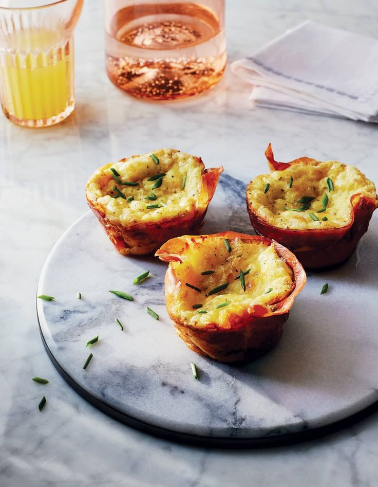 three mini quiche cups on a marble plate