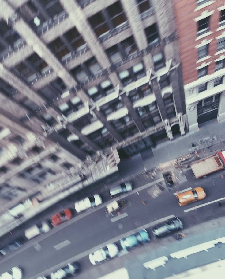 an aerial view of cars and buildings in the city