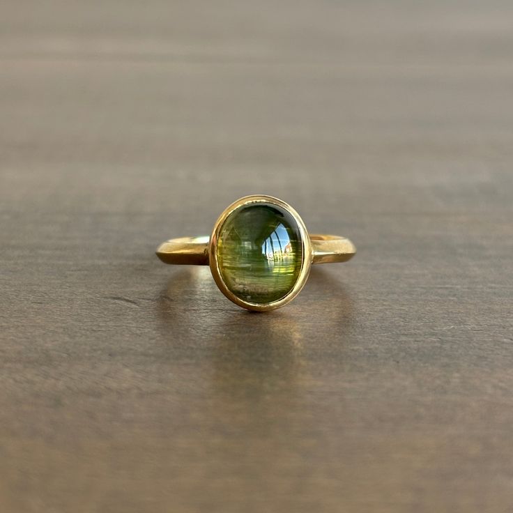 Translucent, vivid green tourmaline is bezel set in bright gold. 18k yellow gold Tourmaline 5/16" x 3/8" Cats Eye Ring, Organic Style, Newport Ri, Eye Ring, Bright Gold, Green Tourmaline, Bezel Setting, Newport, Cat Eye