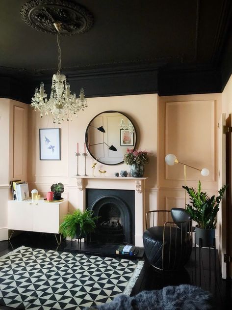 a living room filled with furniture and a large clock on the wall above a fireplace