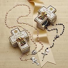 two wooden boxes with rosarys and beads on top of a wood table next to a ribbon