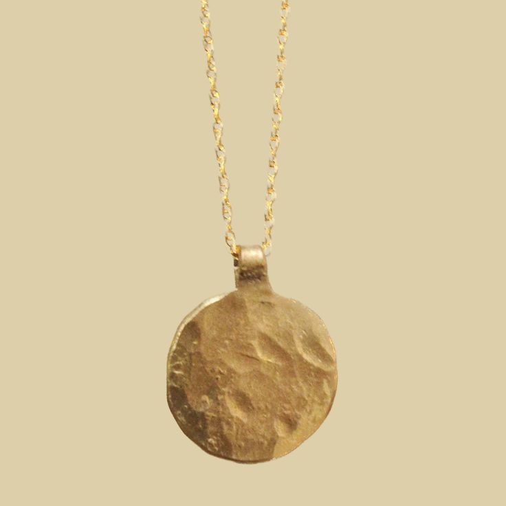 One of our signature pendants in the shape of la luna, a wearable reminder to embrace life's natural rhythms, 18" chain pictured, brass variation comes with 14 K gold filled chain 14k Gold Spiritual Coin Necklace With Round Pendant, Brass Coin Pendant Jewelry, Brass Medallion Necklace Tarnish Resistant, Tarnish Resistant Brass Medallion Necklace, Everyday Moon Phase Pendant Necklace, Tarnish Resistant Recycled Gold Round Pendant Charm Necklace, Everyday Brass Jewelry With Large Pendant, Symbolic Brass Jewelry With Coin Pendant, Symbolic Brass Charm Necklace Tarnish Resistant