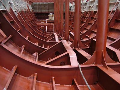 the inside of a large metal structure with lots of pipes