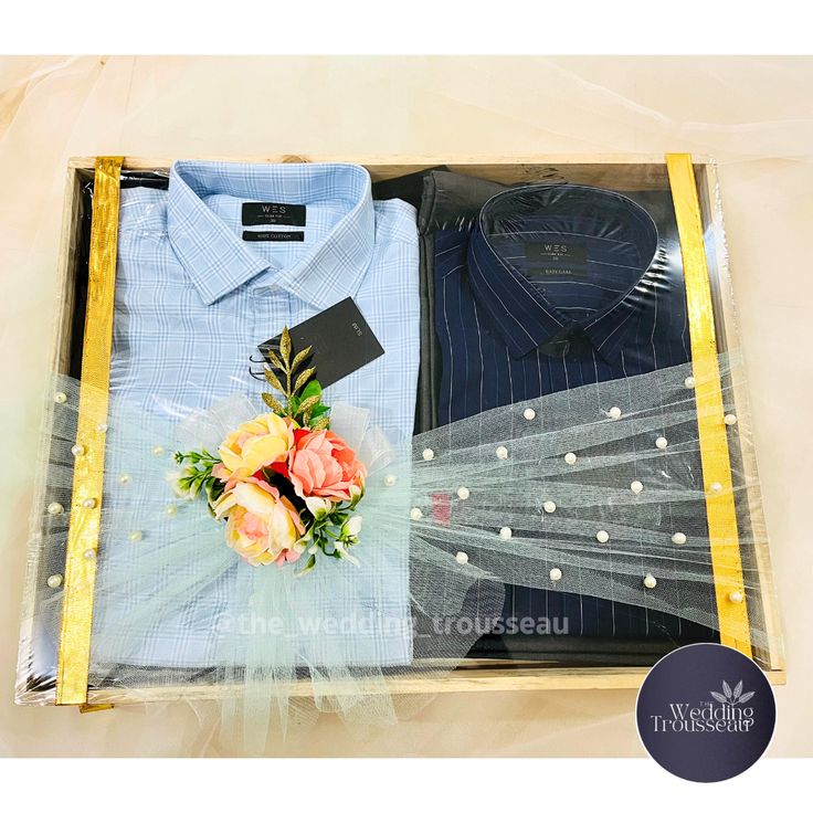 a blue shirt and some flowers in a box