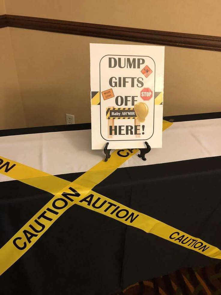 there is a caution sign on top of a table with yellow tape around it that says dump gifts off here