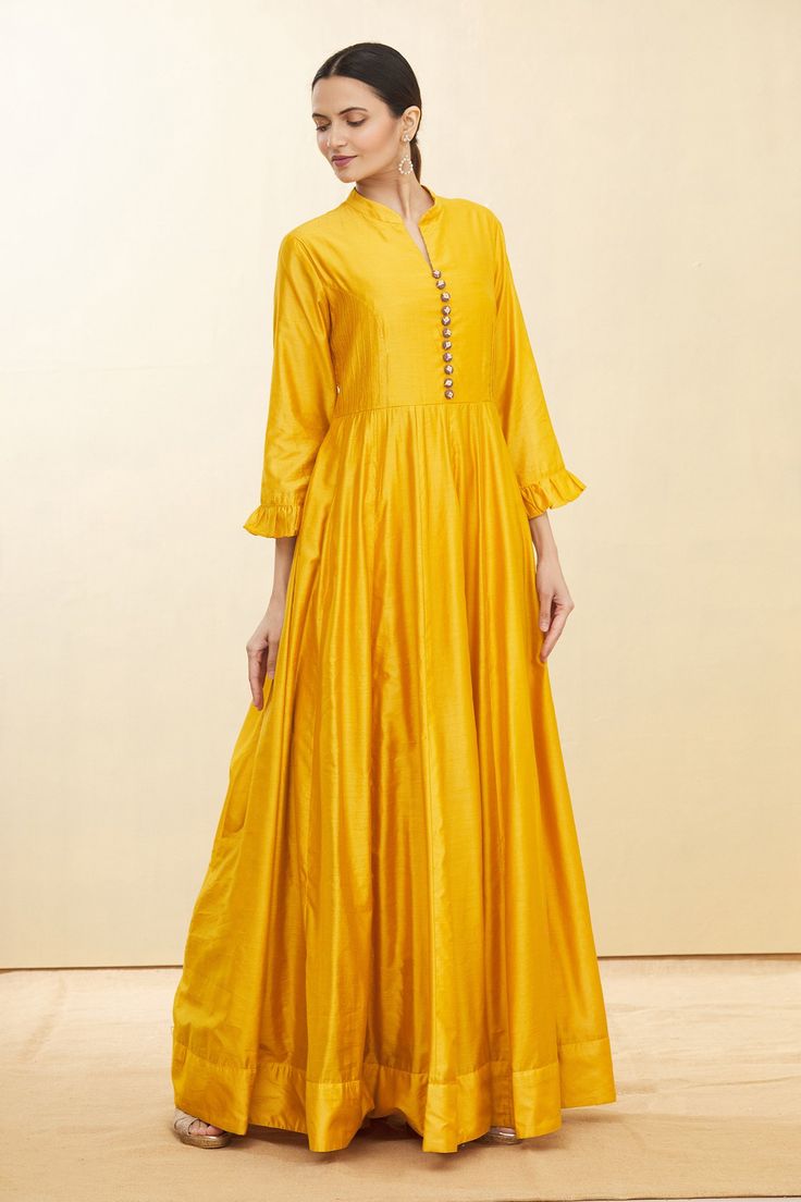 Mustard yellow chanderi anarkali with contrast embroidered buttons, mandarin collar and frill detailing at the sleeves.
Component: 1
Embroidered
Neckline: Mandarin Collar
Sleeve Length: Three Quarter
Fabric: Chanderi
Color: Yellow
Notched mandarin collar
Frill detailing at the sleeves - Aza Fashions Chanderi Anarkali, Embroidered Buttons, Embroidered Neckline, Fashion App, Mandarin Collar, Anarkali, Aza Fashion, Mustard Yellow, No Frills