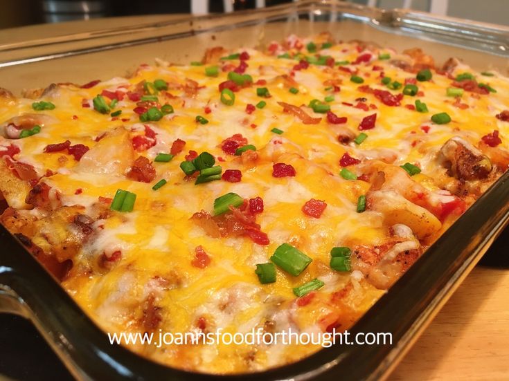 a casserole dish with meat, cheese and green onions