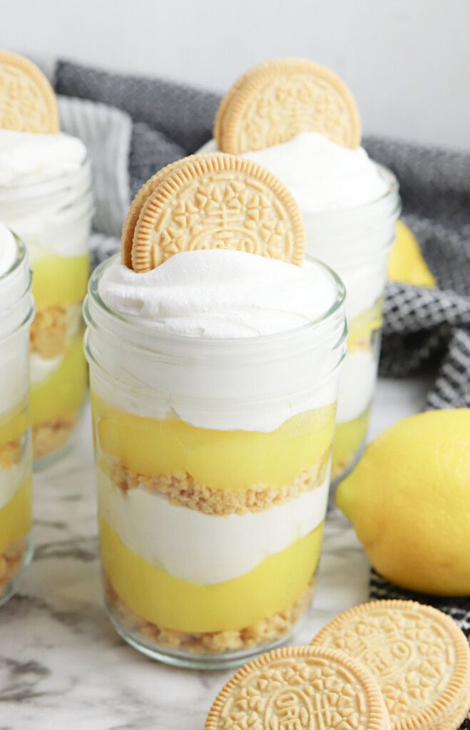 lemonade trifle desserts in mason jars with oreo cookies on the side