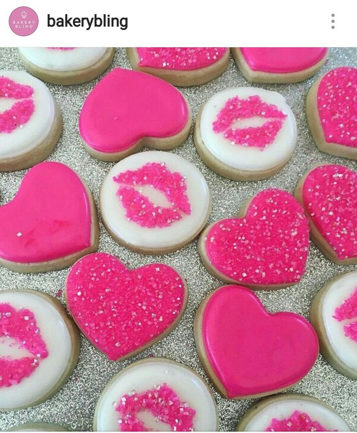 pink and white decorated cookies in the shape of hearts