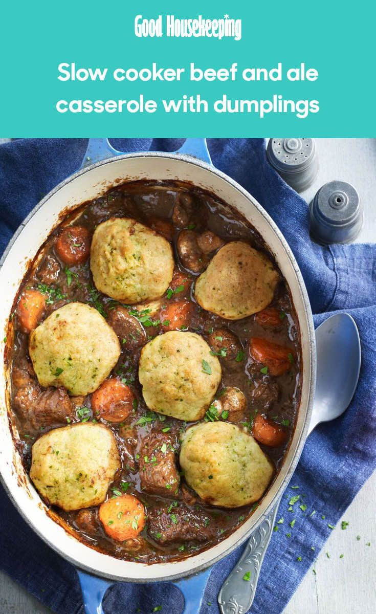 a pot filled with stew and dumplings on top of a blue towel