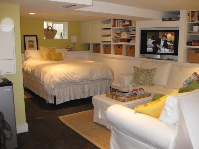 a living room with two beds and a tv in it's centerpieces