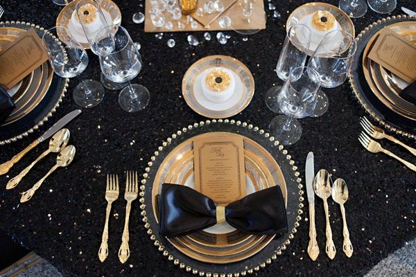 black and gold table setting with place settings