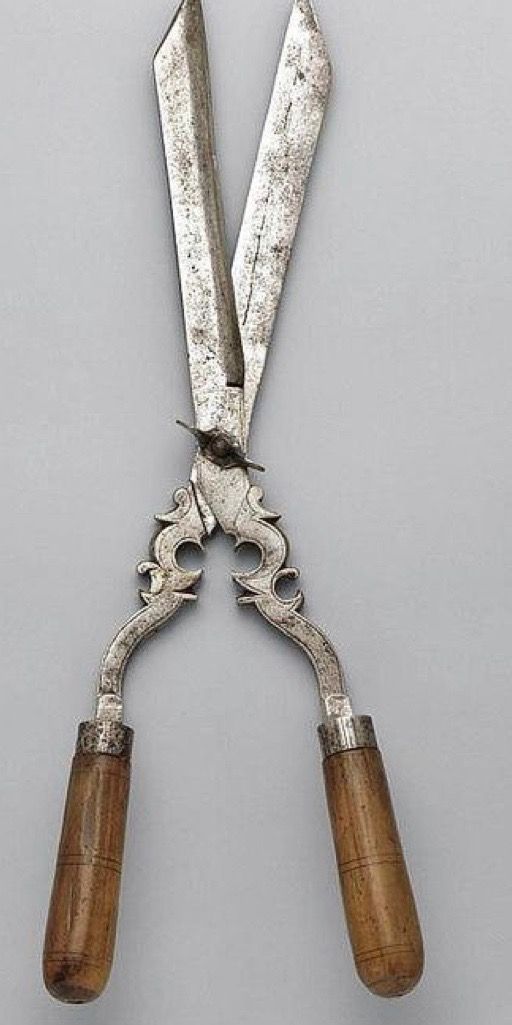 pair of scissors with wooden handles on grey background, possibly from the 19th century or early 20th century