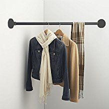 an image of clothes hanging on a rail with scarfs and scarves attached to it