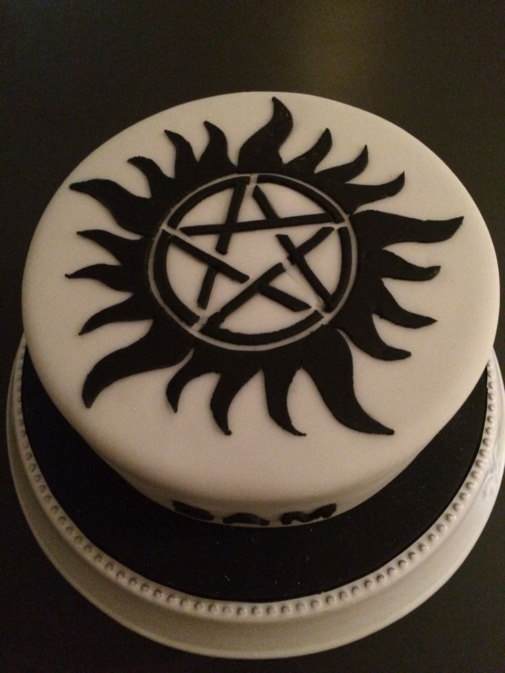 a white cake with black decorations on it