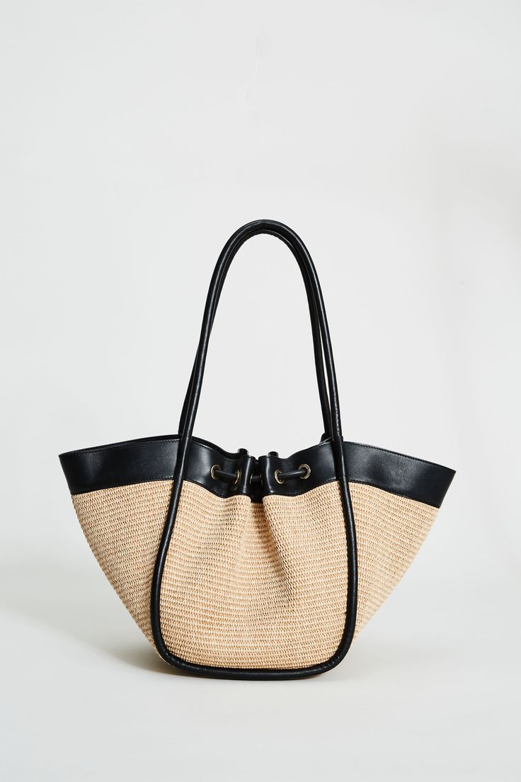 Step into Spring in style with our exclusive Raffia Tote Bag. Handcrafted in Italy, our chic, drawstring handbag is designed in the finest raffia fabric with contrasting Nappa Leather trim & gold handwear. With so many essentials to carry these days, this handbag puts the fashion in function with its knot Closure & ruched detailing. Elie Tahari Exclusive Raffia & Italian Leather Tote Bag with Gold Stud accents & a drawstring Knot Closure Measurements: 10" L, 20" Width, 12" Opening; Base 8"x6" Ma Luxury Straw Tote Bag With Rolled Handles, Luxury Straw Bags For Shopping, Chic Natural Beach Bag With Handles, Chic Double Handle Straw Bag, Chic Straw Beach Bag With Handles, Chic Beach Bag With Braided Handles, Elegant Tote Beach Bag With Braided Handles, Beige Bucket Bag With Rolled Handles For Travel, Elegant Beach Bag With Leather Handles